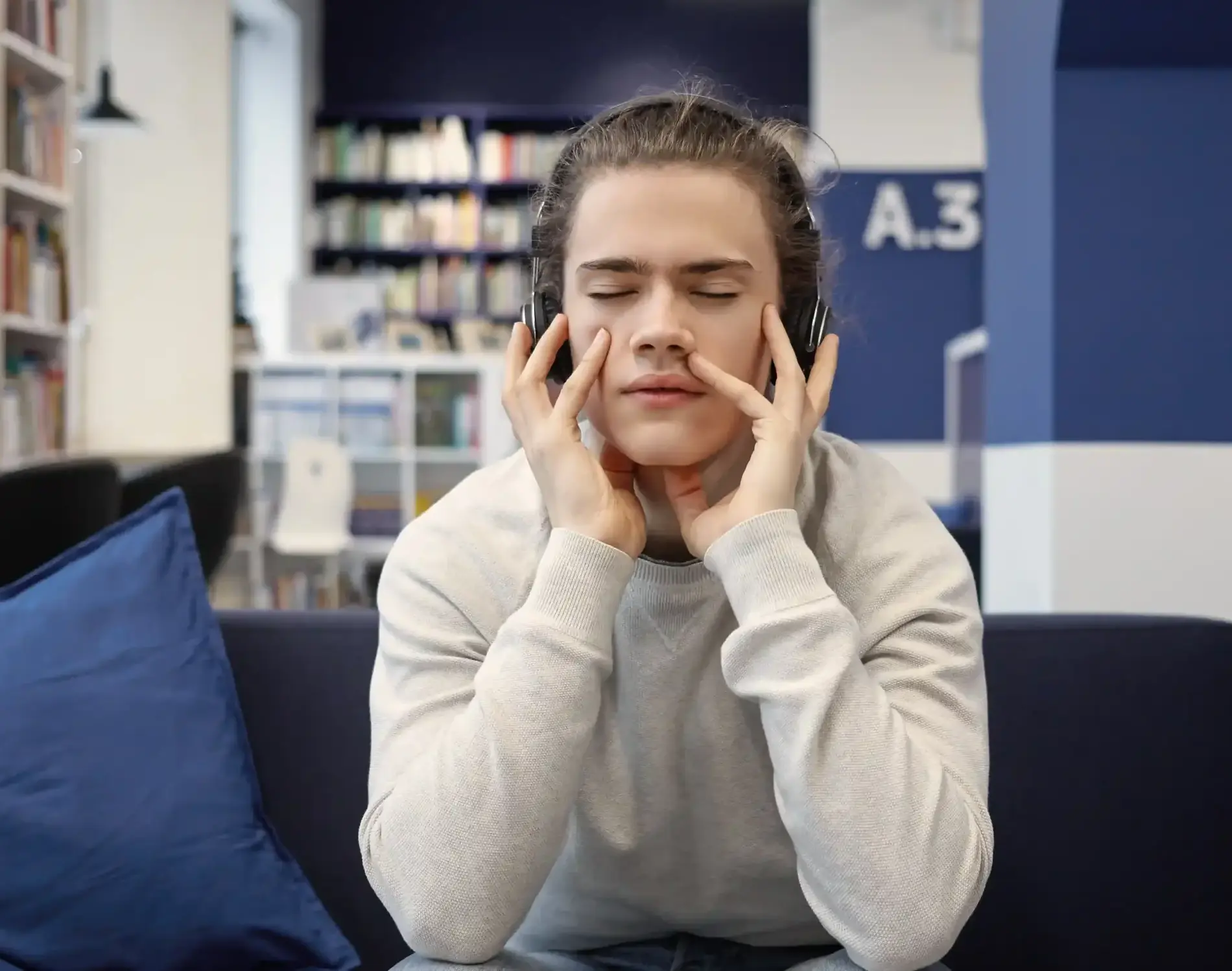 handsome-young-man-meditating-home-wearing-black-headphones-keeping-eyes-closed_11zon